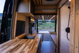 Step inside this modern RV rental! Features a sleek kitchen, comfy dinette, and private shower, all with scenic views.
