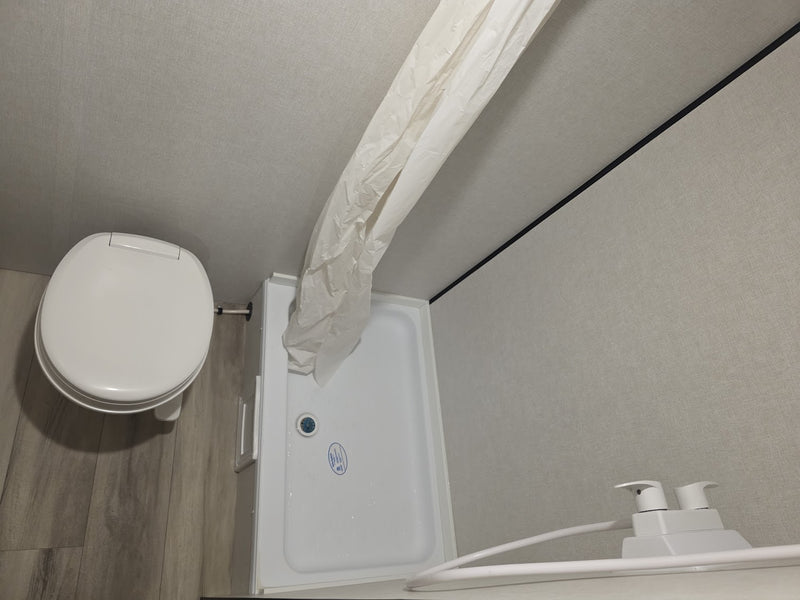  fridge; plus AC unit & sleeping area w/ window.|Compact rv rental interior features a cozy bed — photo 7