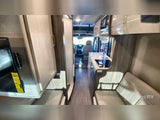 Explore this modern RV rental interior! Features a compact kitchen, comfortable seating, and front cockpit view, ideal for travel.