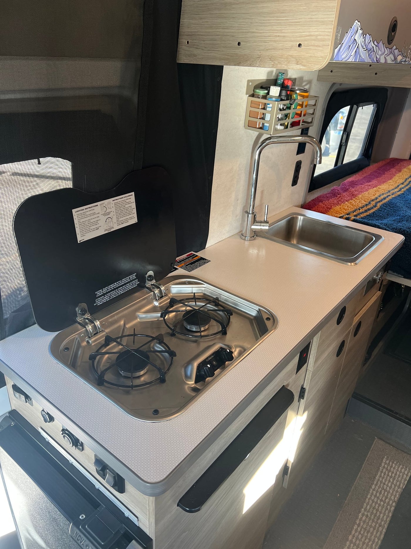  with dark front cabin seats visible.|Spacious RV rental camper van interior: light seats — photo 12
