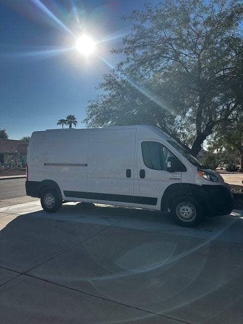  enjoying the view.|Front view of a white Ram ProMaster van — photo 3