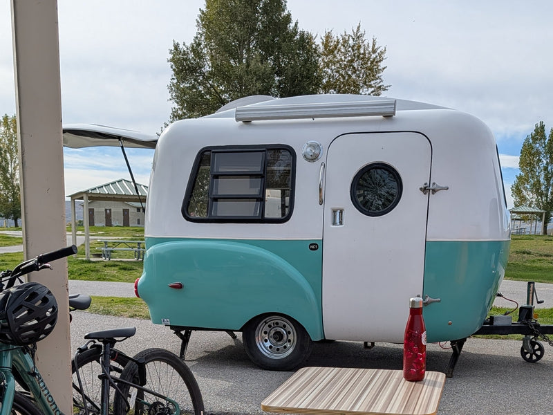  a travel trailer hitched to a car — photo 2