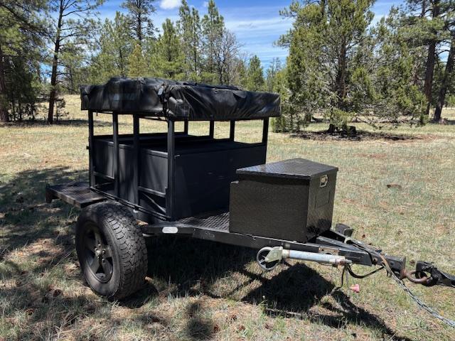  ready for an RV rental camping trip in the sunny outdoors. Ladder & annex.|Rugged RV rental: This off-road trailer opens to reveal a sleep area — photo 2