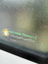 Sticker on an RV rental's textured window announces 'Inverter Powered' for general circuits, microwave, & A/C.
