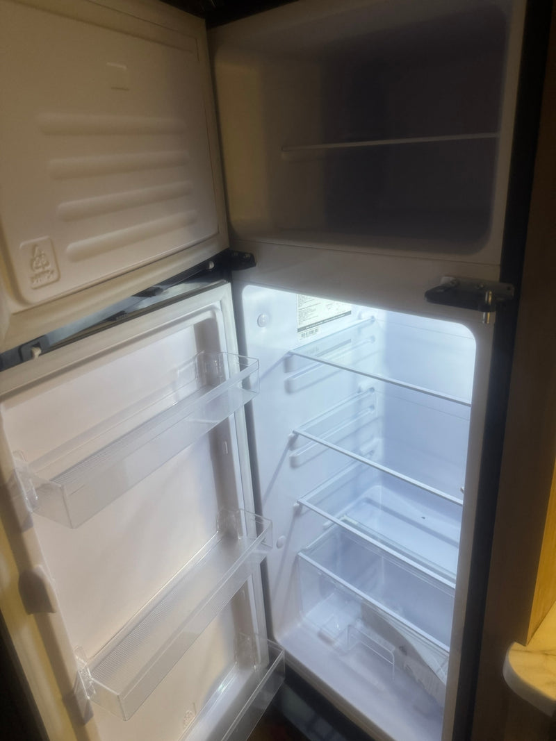  and dinette.|Compact white shower in an RV rental — photo 4