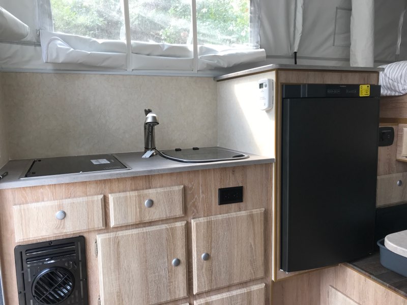  and hamper storage.|Compact RV rental kitchen features a stainless steel sink — photo 5