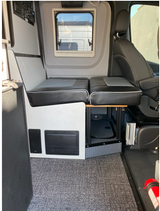 RV rental: Versatile camper van interior featuring comfy seating, window, control panel, and compact shower space.