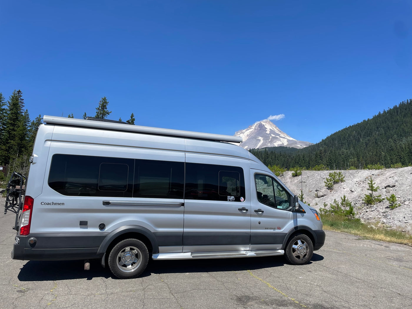 Silver Coachmen Beyond RV rental van facing a majestic snow-capped mountain — photo 1