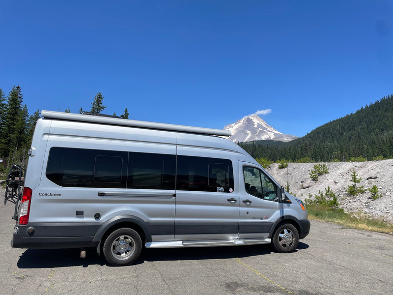 Silver Coachmen Beyond RV rental van facing a majestic snow-capped mountain — photo 1