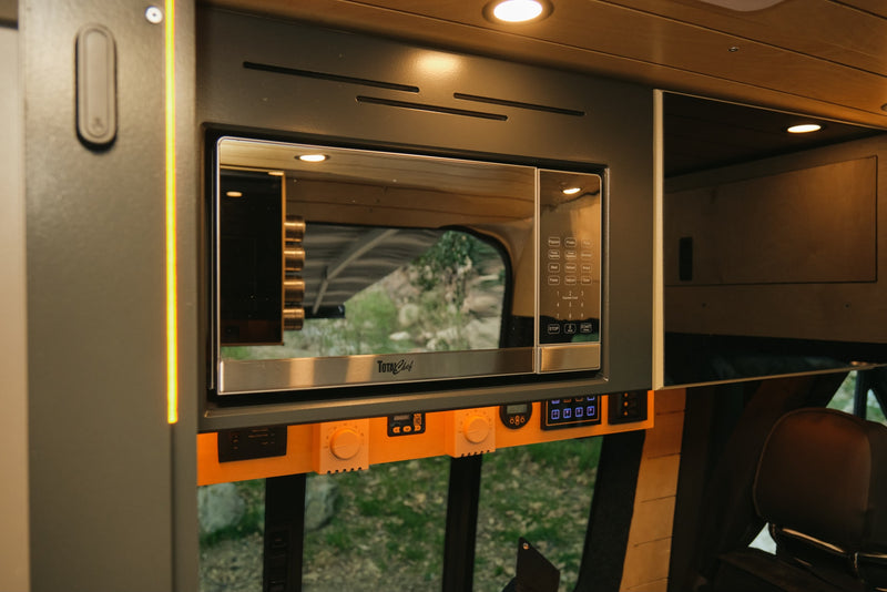  and a scenic view of a tree-filled campsite from the camper van.|RV rental with a seaside kitchen view: modern faucet — photo 9