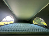 Cozy RV rental pop-top bed features an egg-crate mattress, offering scenic views for your travels.