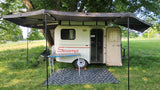 Scamp travel trailer RV rental, with a wide awning for shaded outdoor camping. A cozy tiny home on wheels.