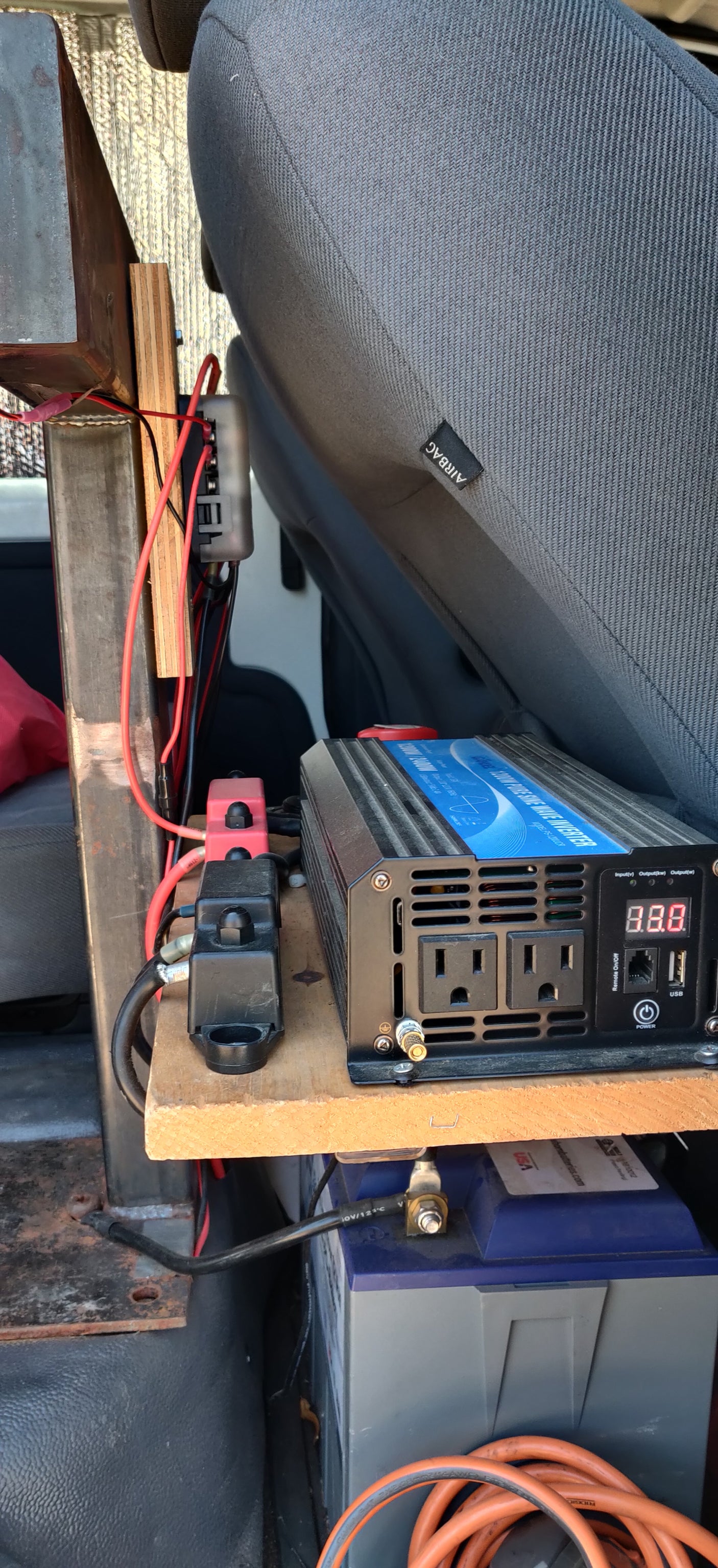An inverter and battery setup provides off-grid power inside an RV rental or camper van.