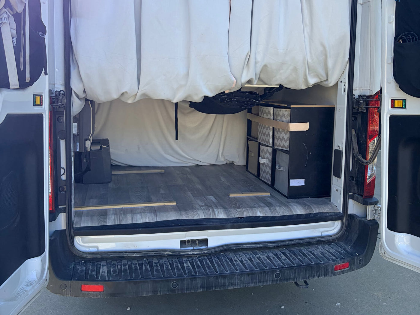  and portable fridge for mobile living.|Efficient RV rental kitchen featuring a stainless steel sink — photo 9