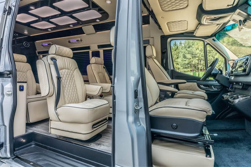 Luxurious rv rental interior with cream leather captain's chairs — photo 1