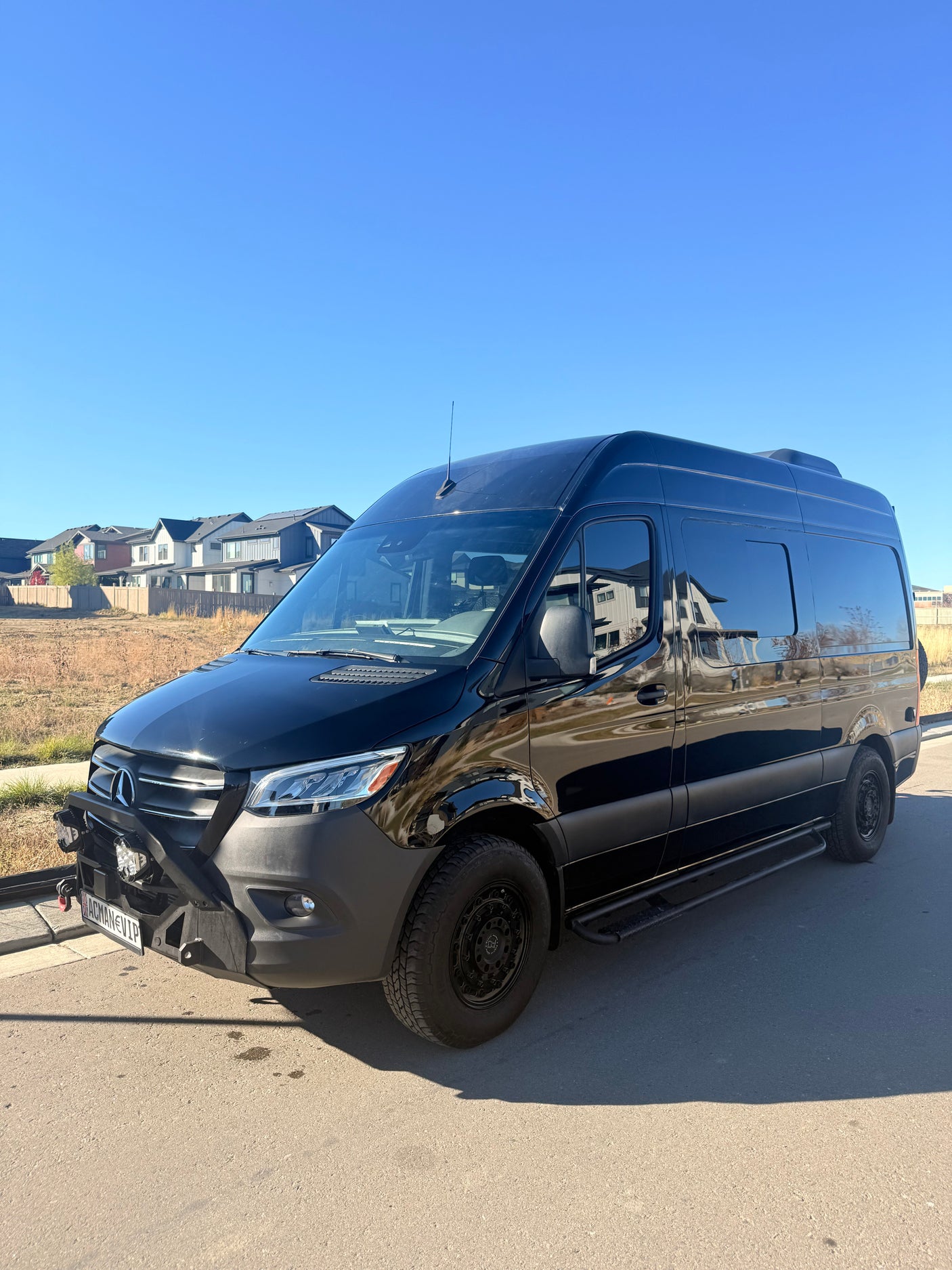 Black, customized Mercedes-Benz Sprinter van, perfect for your next rv rental adventure or road trip.