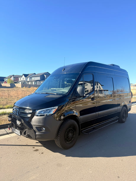 Black, customized Mercedes-Benz Sprinter van, perfect for your next rv rental adventure or road trip.