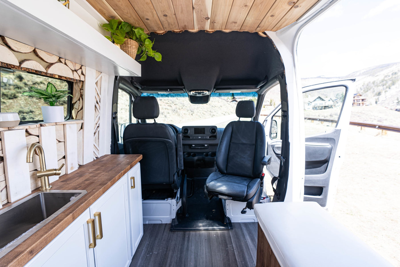  and stylish wood wall accents.|Interior of a modern camper van RV rental with a cozy bed — photo 4