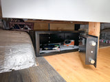 Keep items secure in your RV rental with this built-in safe, open to show a camera & documents.