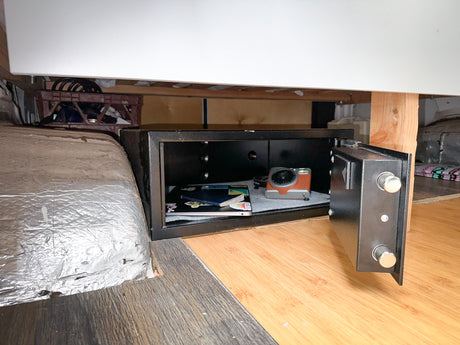 Keep items secure in your RV rental with this built-in safe, open to show a camera & documents.
