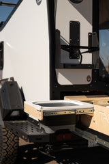This RV rental features an outdoor pull-out kitchen with a collapsible sink for convenient camping.