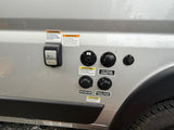 RV rental utility panel: power (30A), cable, city & fresh water, and black tank flush connections on the side.