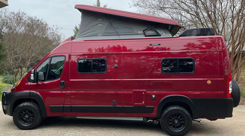  is ready for adventure with its custom modifications.|Front view of a rugged maroon and black Ram ProMaster van — photo 8