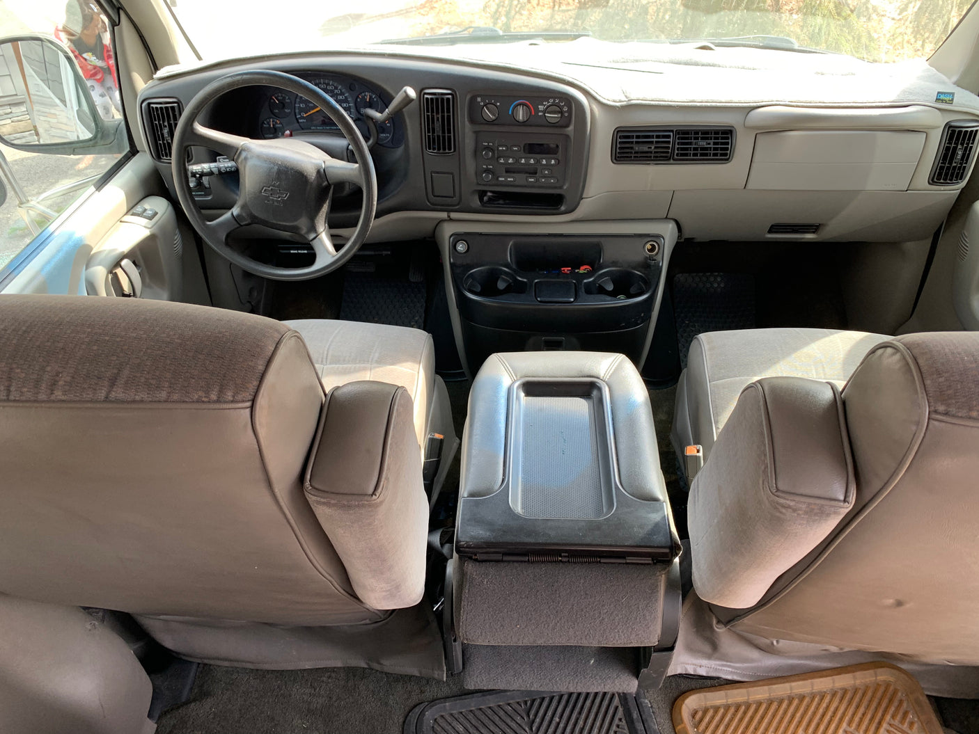 Interior of an RV rental showing the dashboard, steering wheel, and front seats. Ideal for road trips.