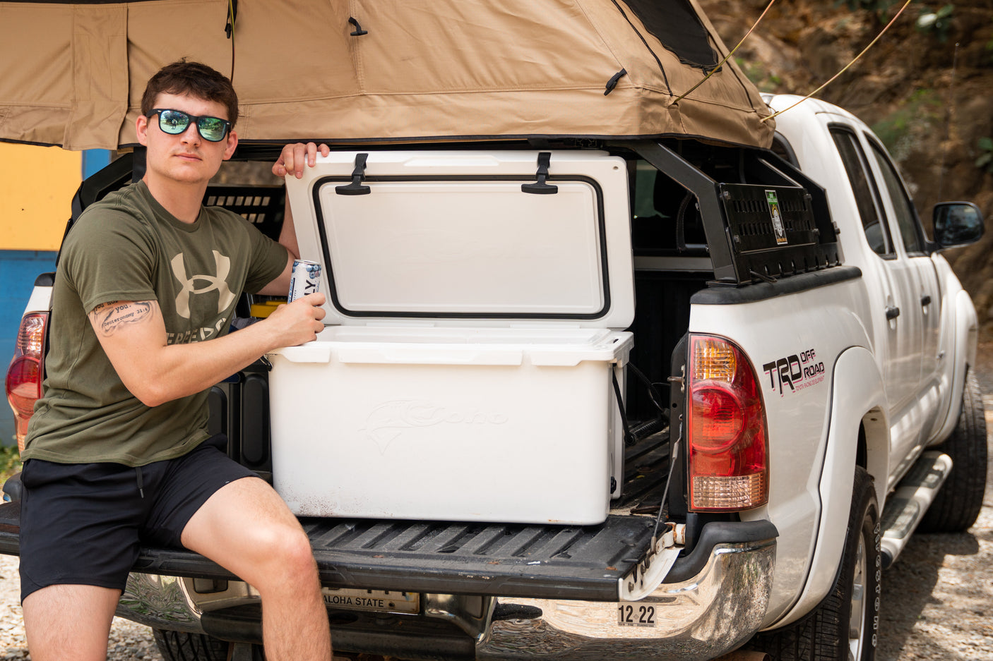 This truck's rooftop tent and cooler provide an ideal RV rental setup for outdoor adventure and camping.