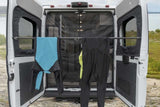 RV rental's rear doors open, featuring a drying bar for activewear. Ideal for adventurers to dry gear outdoors.