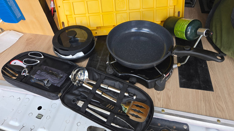 RV rental camp kitchen setup: portable gas stove with pan & pot, plus a compact bag of cooking utensils. — photo 17