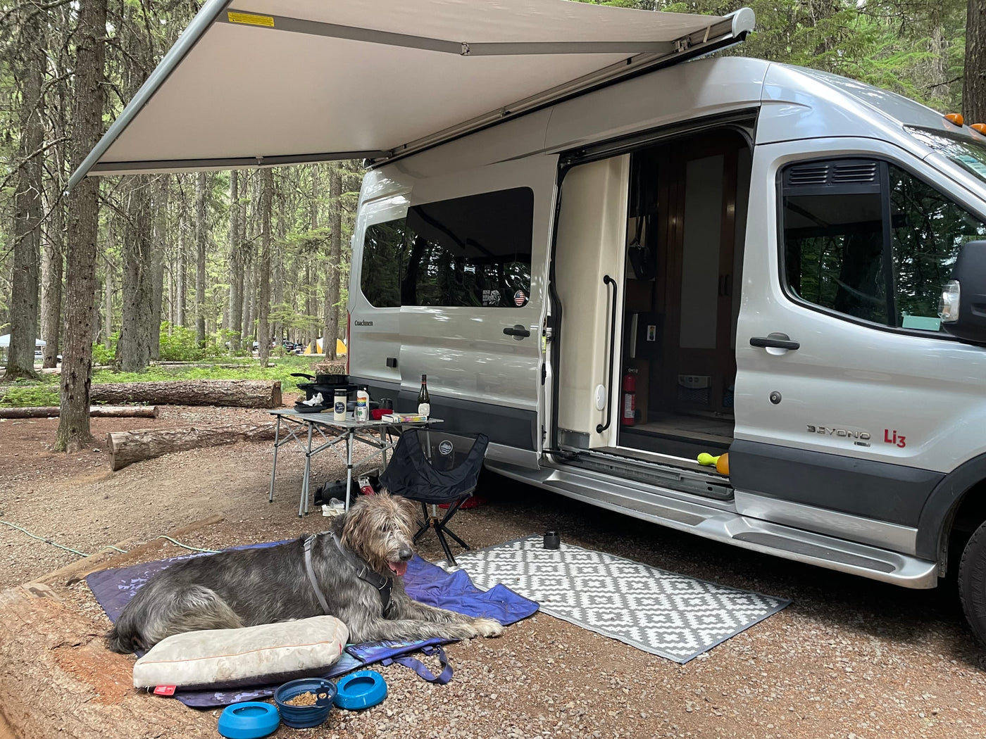  and refrigerator. Functional camper van living space.|An RV rental camper van with an awning out — photo 13