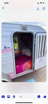 Cozy and colorful rv rental: A charming pink & white camper with a vibrant interior, ready for adventure.
