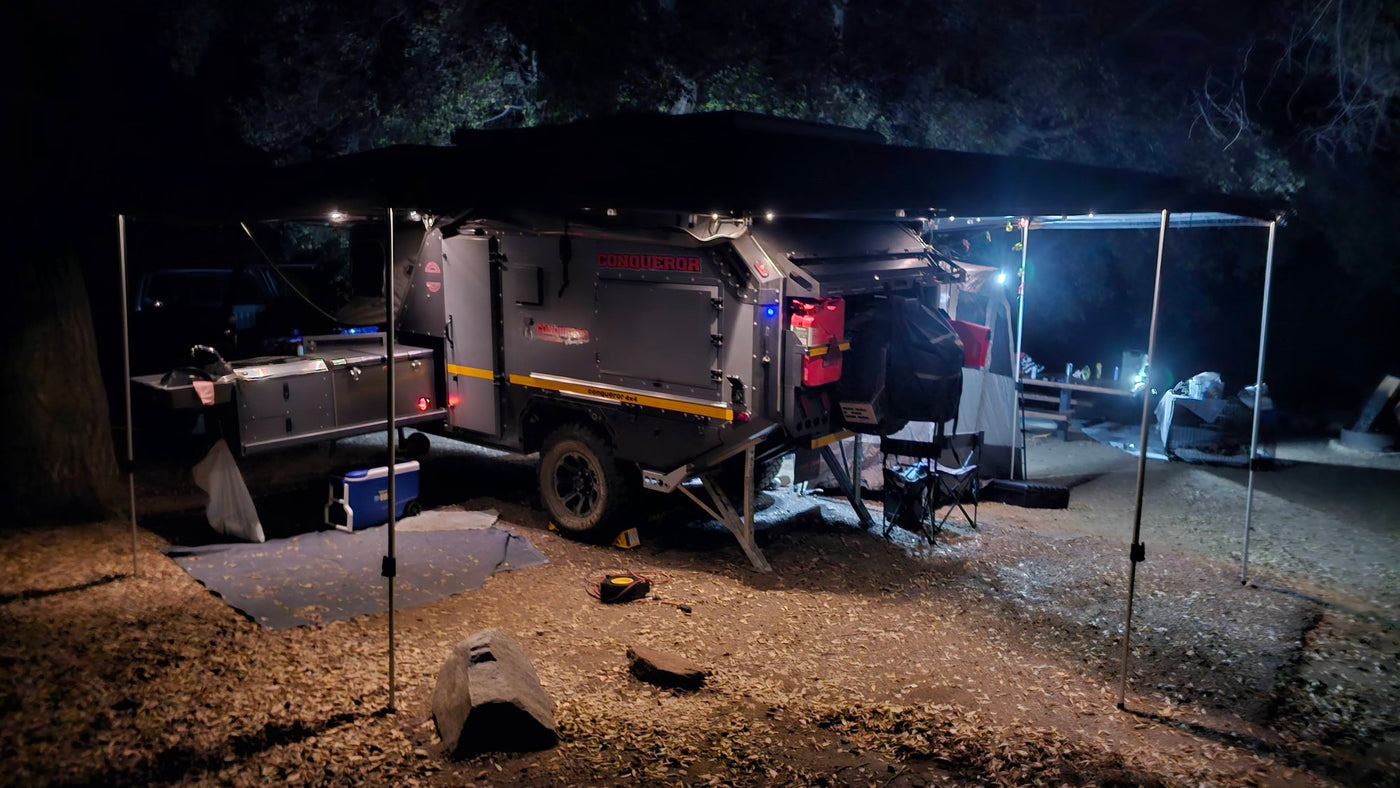 Nighttime setup of a Conqueror overland camping trailer, fully illuminated. Perfect for an RV rental adventure. — photo 15