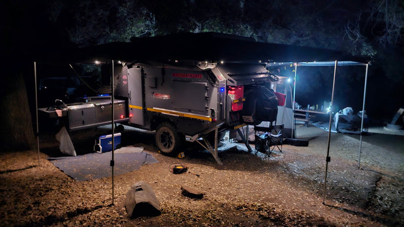 Nighttime setup of a Conqueror overland camping trailer, fully illuminated. Perfect for an RV rental adventure. — photo 15