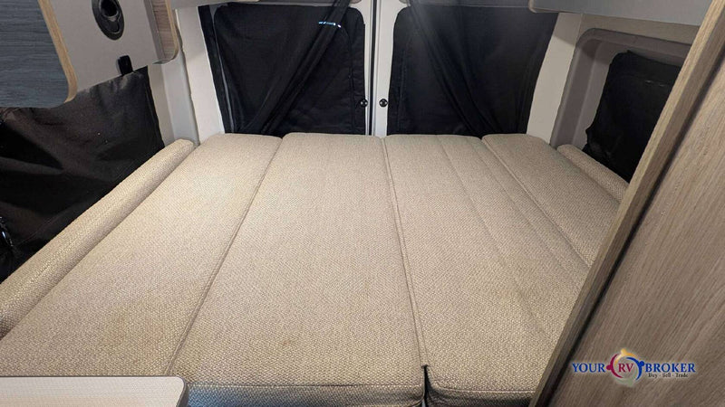  and floor storage.|Compact RV rental kitchen features a sink with a faucet — photo 11