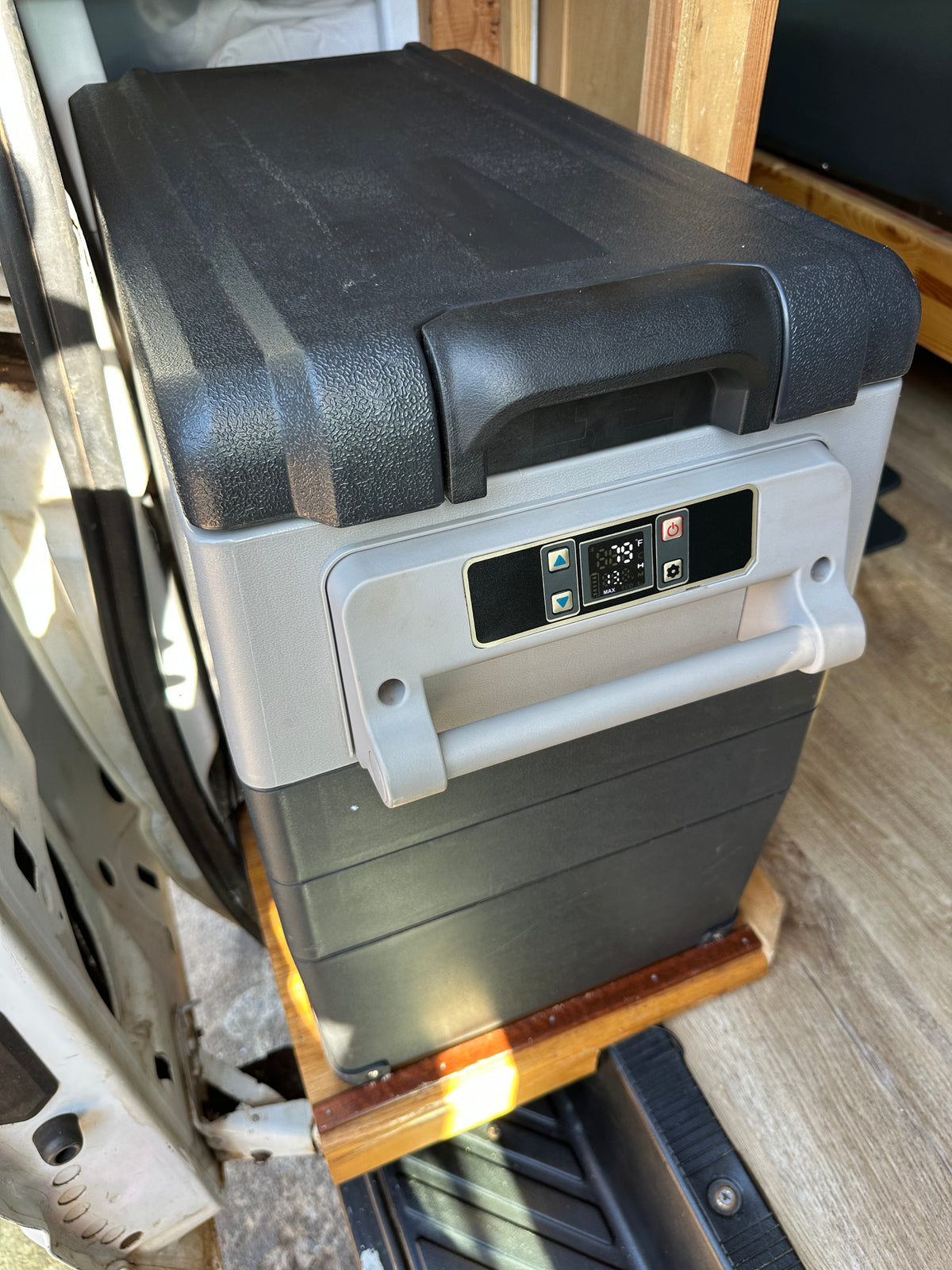 A grey and black portable electric cooler displays 79°F, nestled in an RV rental for convenient travel and camping. — photo 12