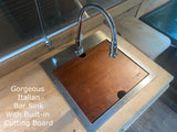 Multi-functional Italian bar sink with built-in cutting board, perfect for a luxurious RV rental kitchen.