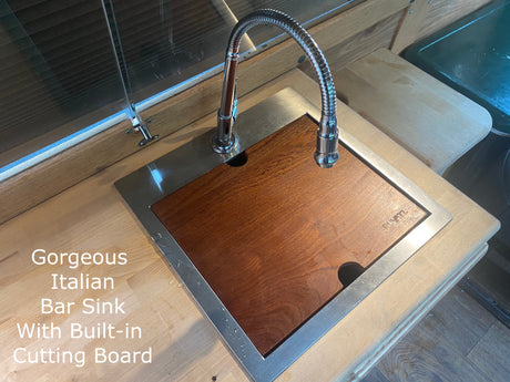 Multi-functional Italian bar sink with built-in cutting board, perfect for a luxurious RV rental kitchen.