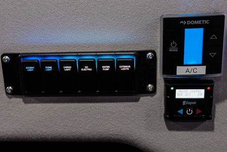 RV rental interior controls: Main panel for lights, power, water pump, plus Dometic A/C and Espar heater.