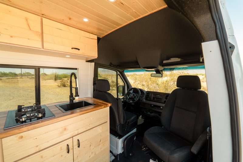  revealing a custom wood interior.|Experience van life: This rv rental shows a cozy camper interior with wooden ceiling — photo 7