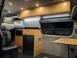 Experience comfort in this RV rental: bamboo kitchenette, microwave, fridge, and bed. Perfect for your road trips.