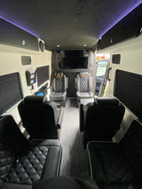 Step inside this luxury RV rental: featuring custom seating, a starry ceiling, and a large entertainment system for ultimate comfort.