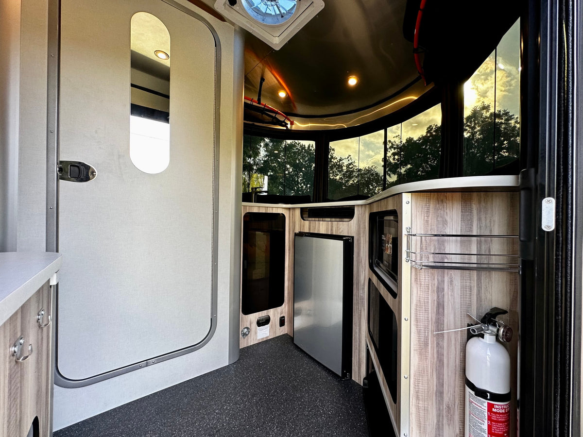  ideal for rv rental.|Compact and functional RV rental interior featuring a dinette with views outside and a self-contained bathroom with shower and toilet.|Modern rv rental interior: kitchen with fridge — photo 6
