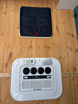 RV rental interior with OutEquip climate control (69°F), air vents, remote, and a black padded cover on wood paneling.