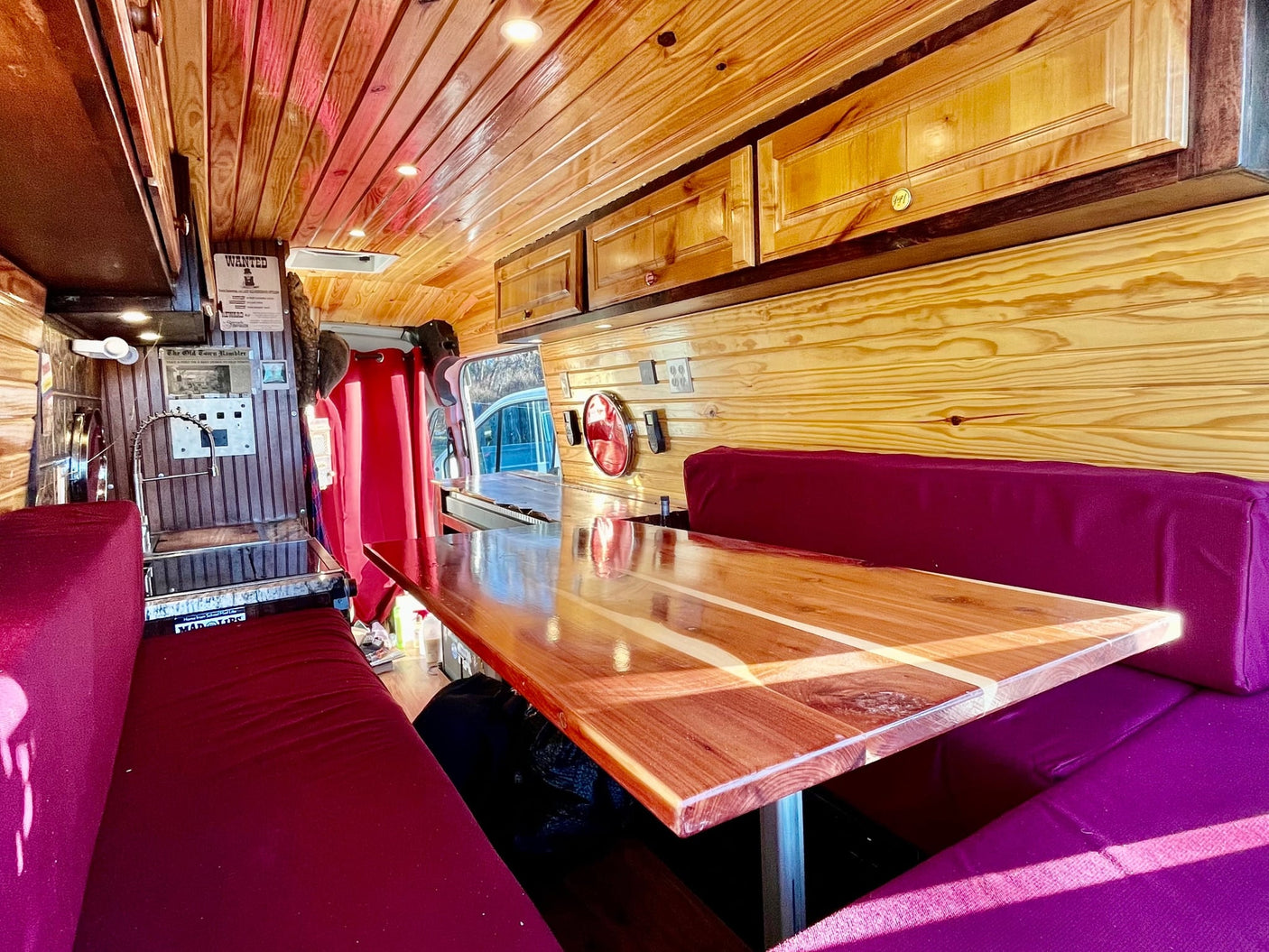  warm wood interior with comfy purple benches & polished table