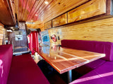  warm wood interior with comfy purple benches & polished table