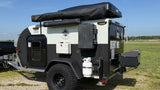 This rugged off-road teardrop trailer, equipped with a roof tent, storage, and propane, is available for RV rental.