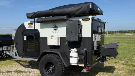 This rugged off-road teardrop trailer, equipped with a roof tent, storage, and propane, is available for RV rental.