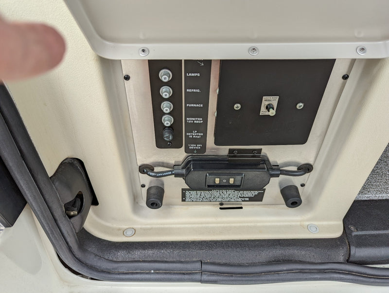 RV rental control panel showing fuses for lamps, fridge, furnace, and a GFI device for power management. — photo 9